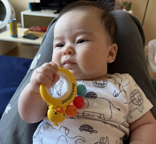 Flo grabbing a rattle