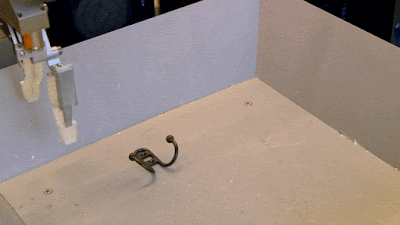 a robot hand grasping an object clumsily